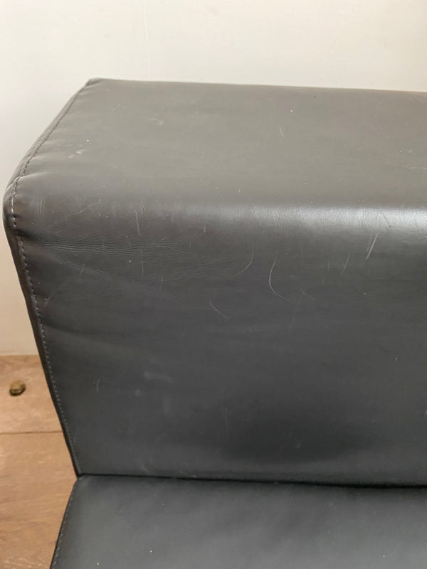 A Kartell by Piero Lissoni 'Plastics' sofa in black.